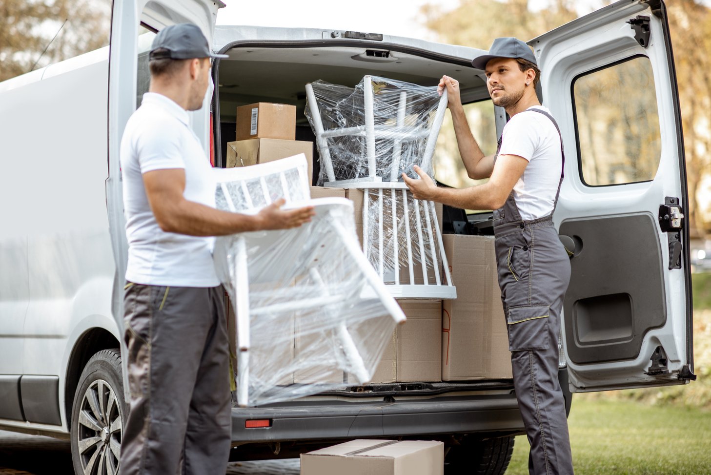 Delivery Company Employees Unloading Cargo Van Vehicle